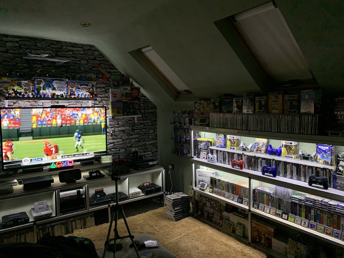 KRASHOVARIDE's tweet image. Finally got round to putting some under shelf lighting in, still unsure with what’s going where and more shelving needed for other side and rear wall but slowly getting there. Used the estate agents trick, right by my feet is organised chaos!! 😂#gamesroom #gamingcommunity