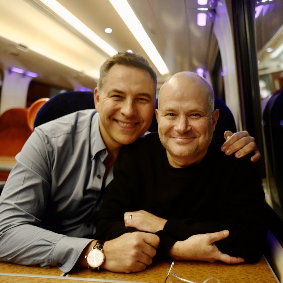 davidwalliams's tweet photo. On the train home from Stratford Upon Avon with my best friend Robin. I took him to see the @robbiewilliams musical of ‘The Boy in the Dress’ @TheRSC The ⭐️⭐️⭐️⭐️⭐️ show has grown since it opened last year, and is getting better &amp; better all the time. It runs until 8th of March. https://t.co/9PCO6YGHP8