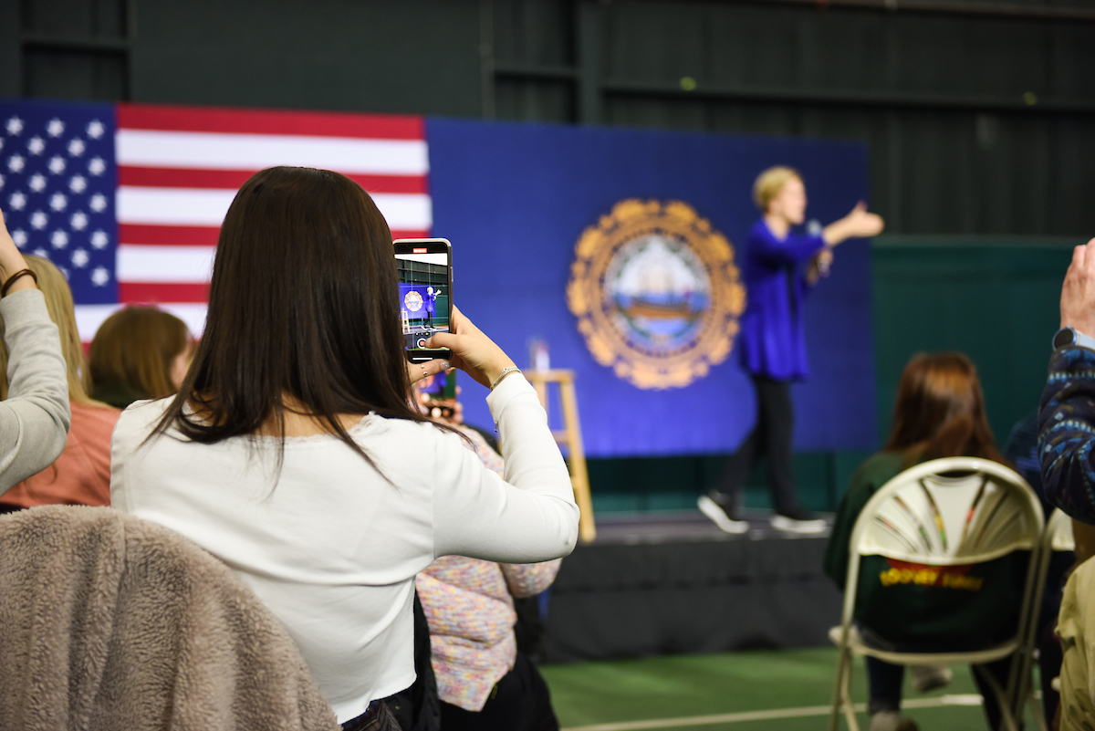 Supporter takes a photo of Elizabeth Warren at the Milford town hall.