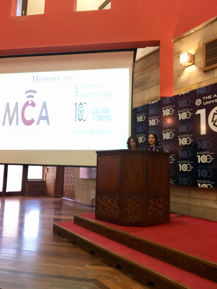 AUCJRMC's tweet photo. The MCA leadership Rehab Shalaby (left) and Nada Tarek (right) with opening comments -at the JRMC Fall 2019 Honors Ceremony. @GAPP_AUC @AUC #JRMCsuccess https://t.co/WUMKdGcA4F