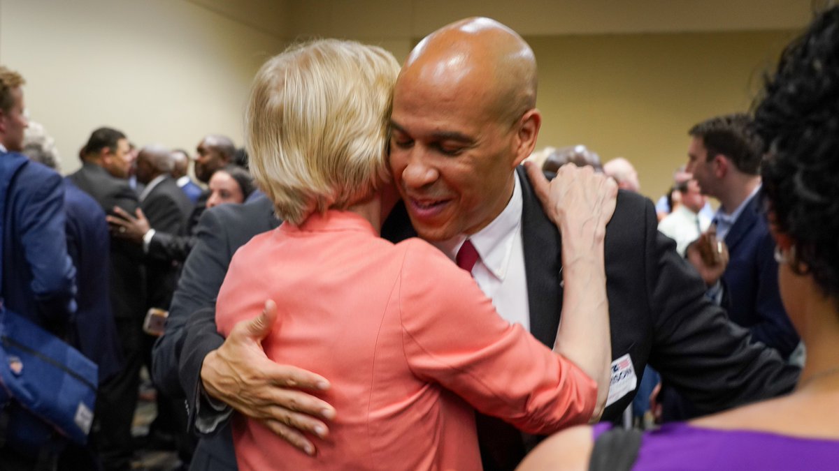 Elizabeth Warren hugs Cory Booker.