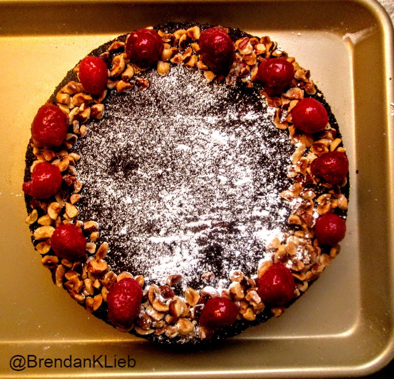 Dessert this evening is a flourless dark chocolate &amp; raspberry torte.
It's topped with glazed fresh raspberries &amp; chopped hazelnuts. 
Happy Monday! 😊
#baking #chocolate #cake #raspberries #hazelnuts #dessert