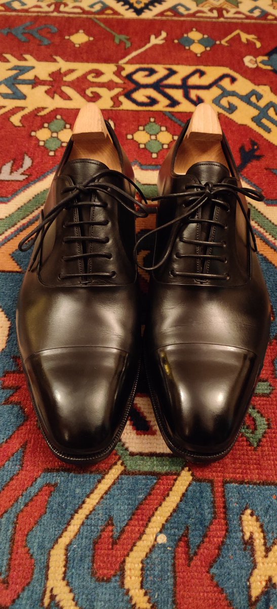 Invest in a pair of high quality black cap-toe Oxford shoes. They're timeless and will last a lifetime if properly cared for.