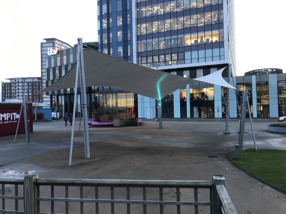 RydalEng's tweet photo. This hexagonal fabric canopy at #MediaCity is waiting for warmer weather before it attracts outdoor eaters again.  We designed it with 6 sides to give a better coverage of the footprint area &amp; the rear tension stays to help it withstand the high winds around this windy location. https://t.co/2RW7sdgf36