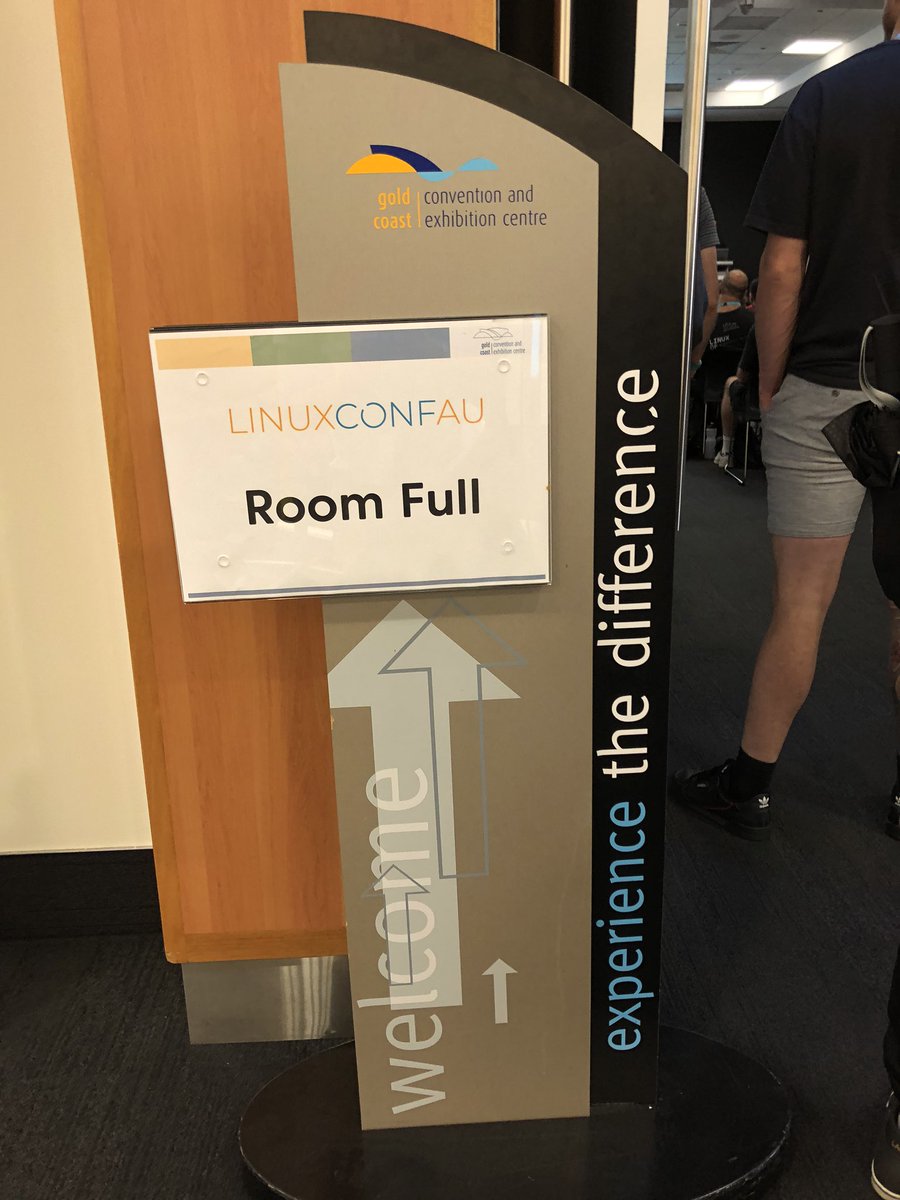 A sign outside room 6 saying, “Room Full”