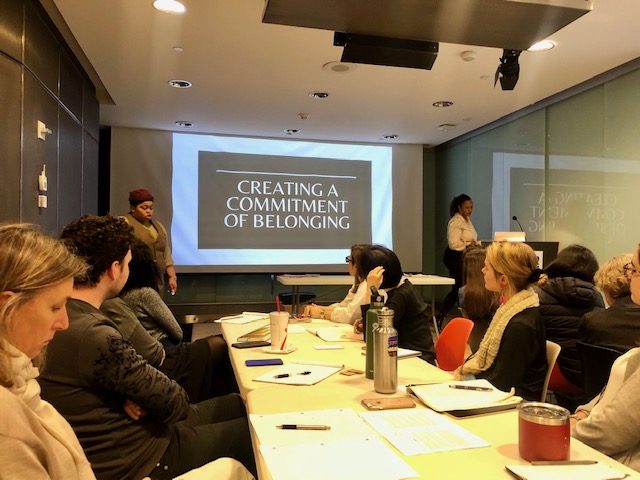 Shanelle and Fresco present to Cooper Hewitt staff in front of a slide that says, Creating a Commitment of Belonging. 