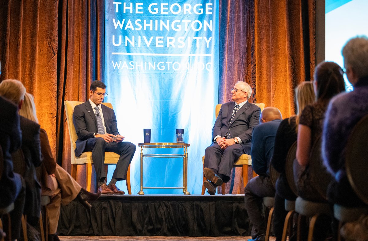 President LeBlanc and alumnus sitting in chairs on stage for interview.
