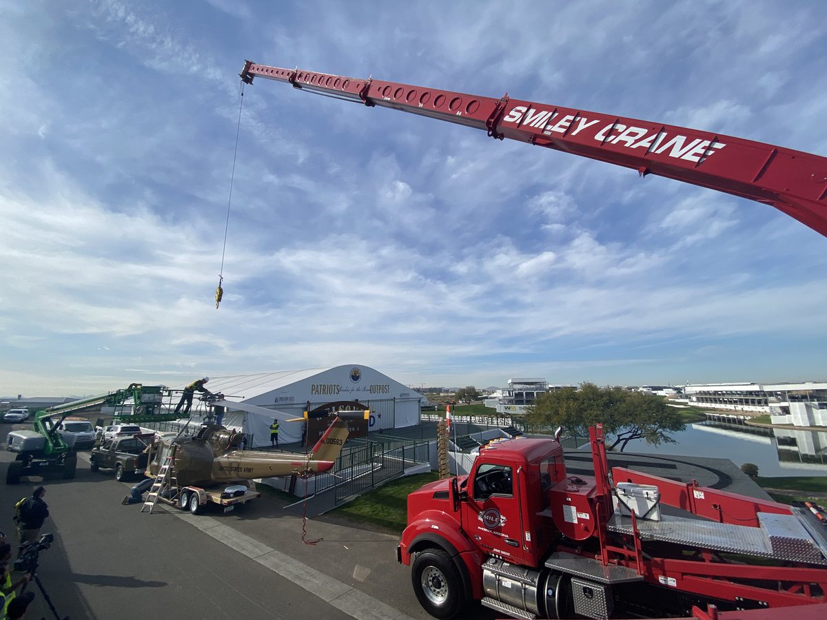 #SmileyCrane is out here at TPC today working to lift a helicopter for the veteran + first responder tent at the #WasteManagement #PhoenixOpen
