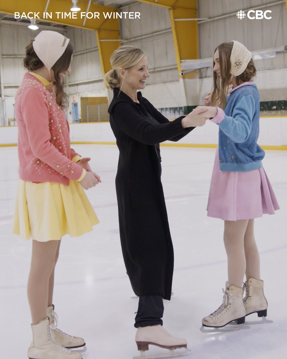 Sandra Bezic teaching two young teens in dainty, 1950's dresses how to skate on ice.