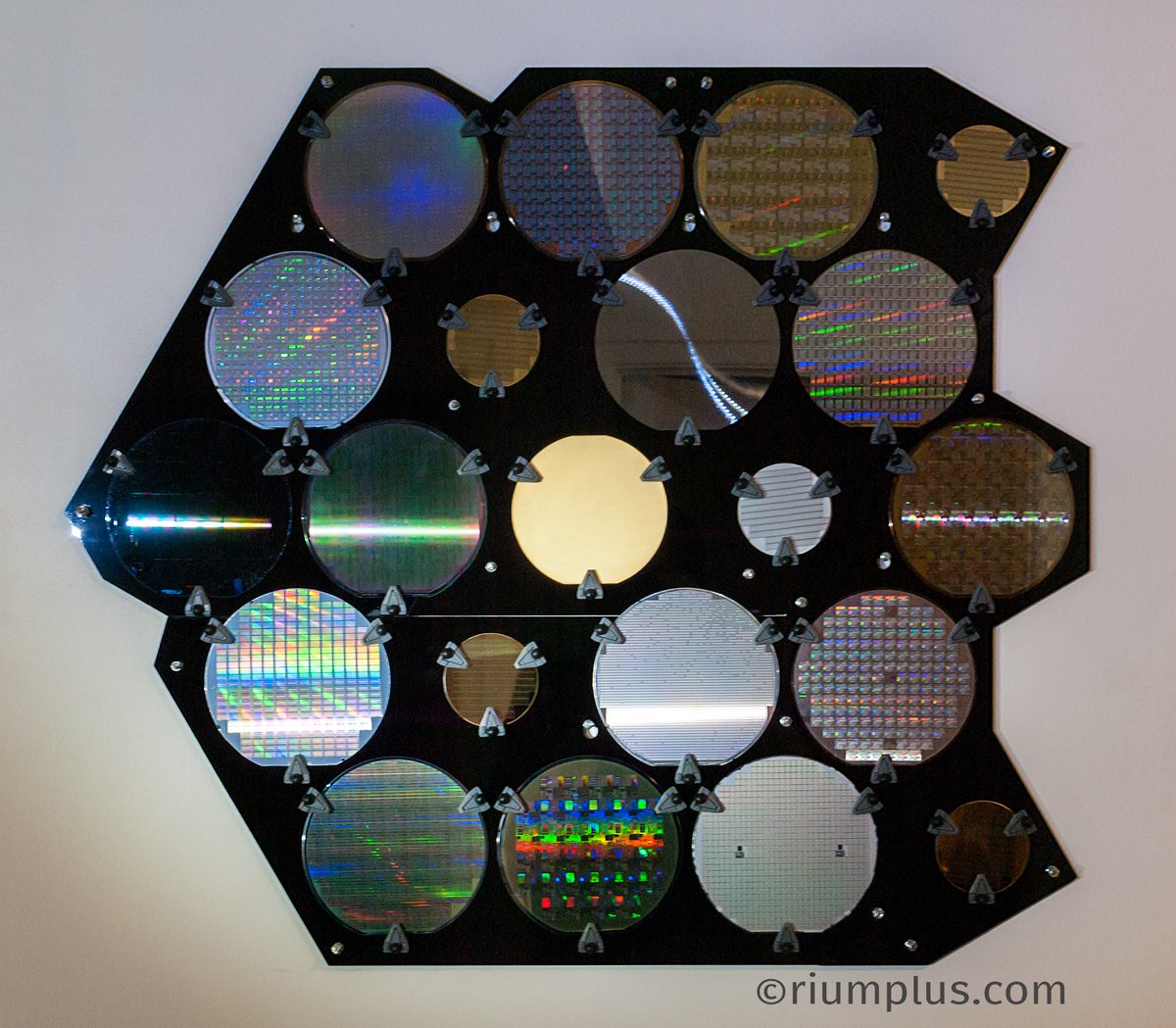 An array of 21 Silicon Wafers hung on a wall. They sparkle and make cool rainbow reflection patterns when caught in the right light.