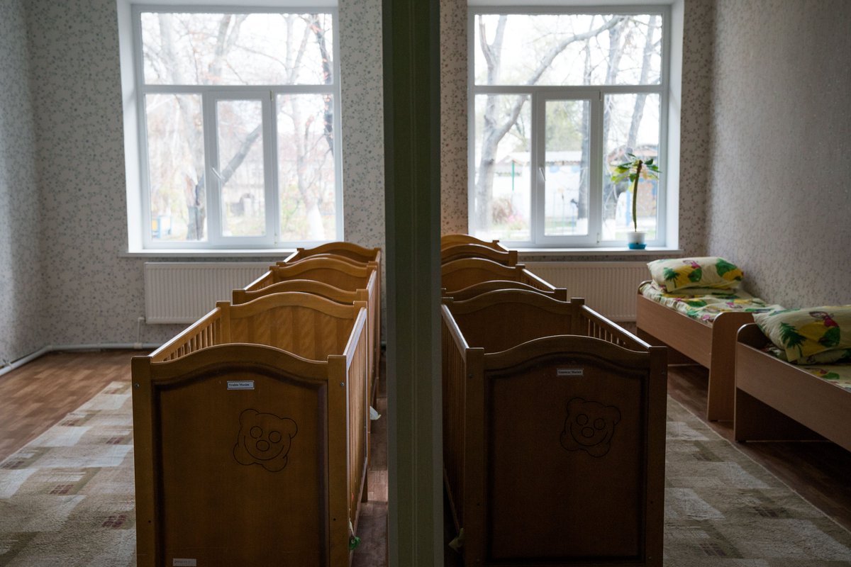 Baby cribs and children's beds in an orphanage bedroom