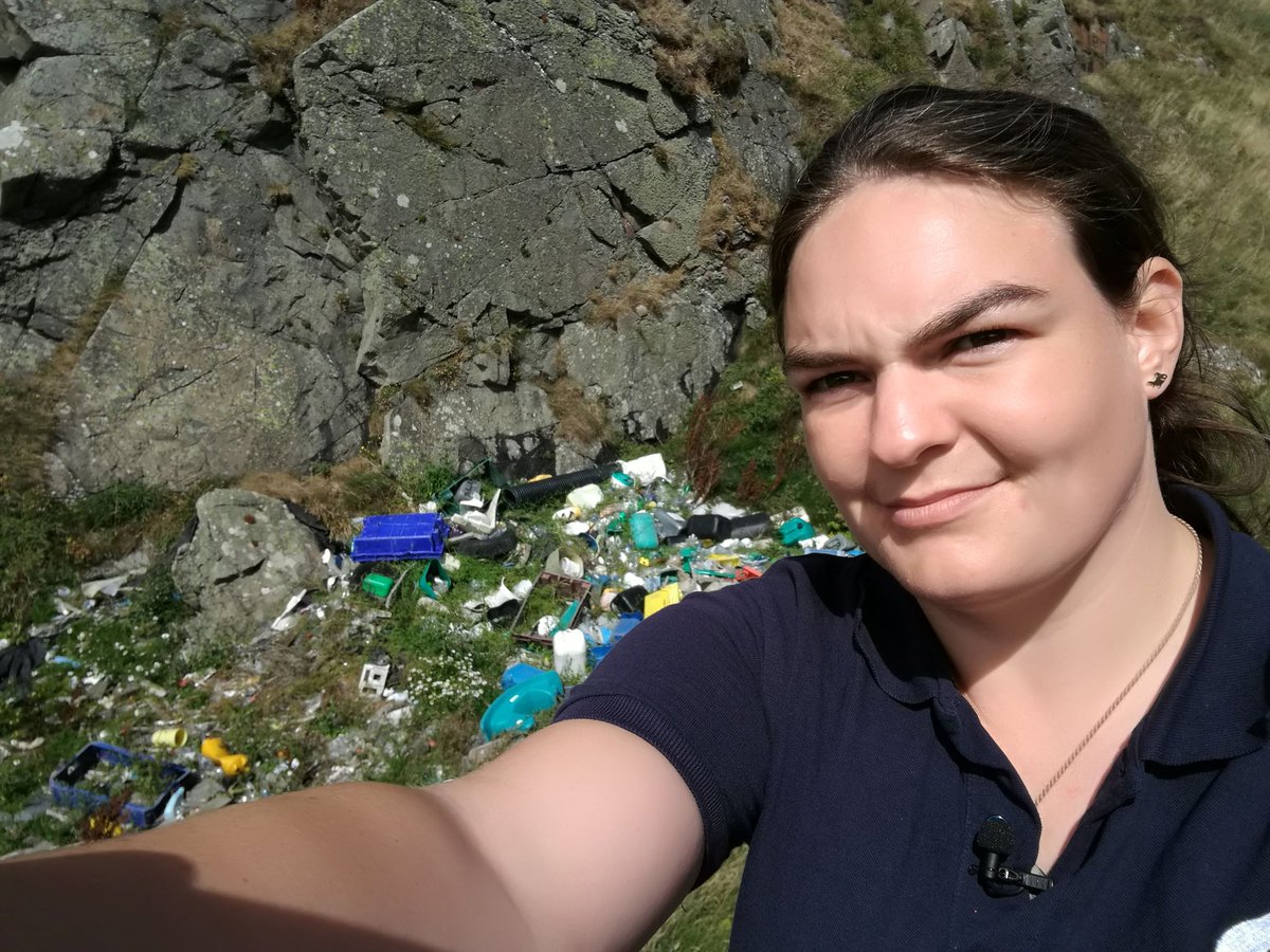Catherine infront of a stretch of Scottish coastline choking with waste