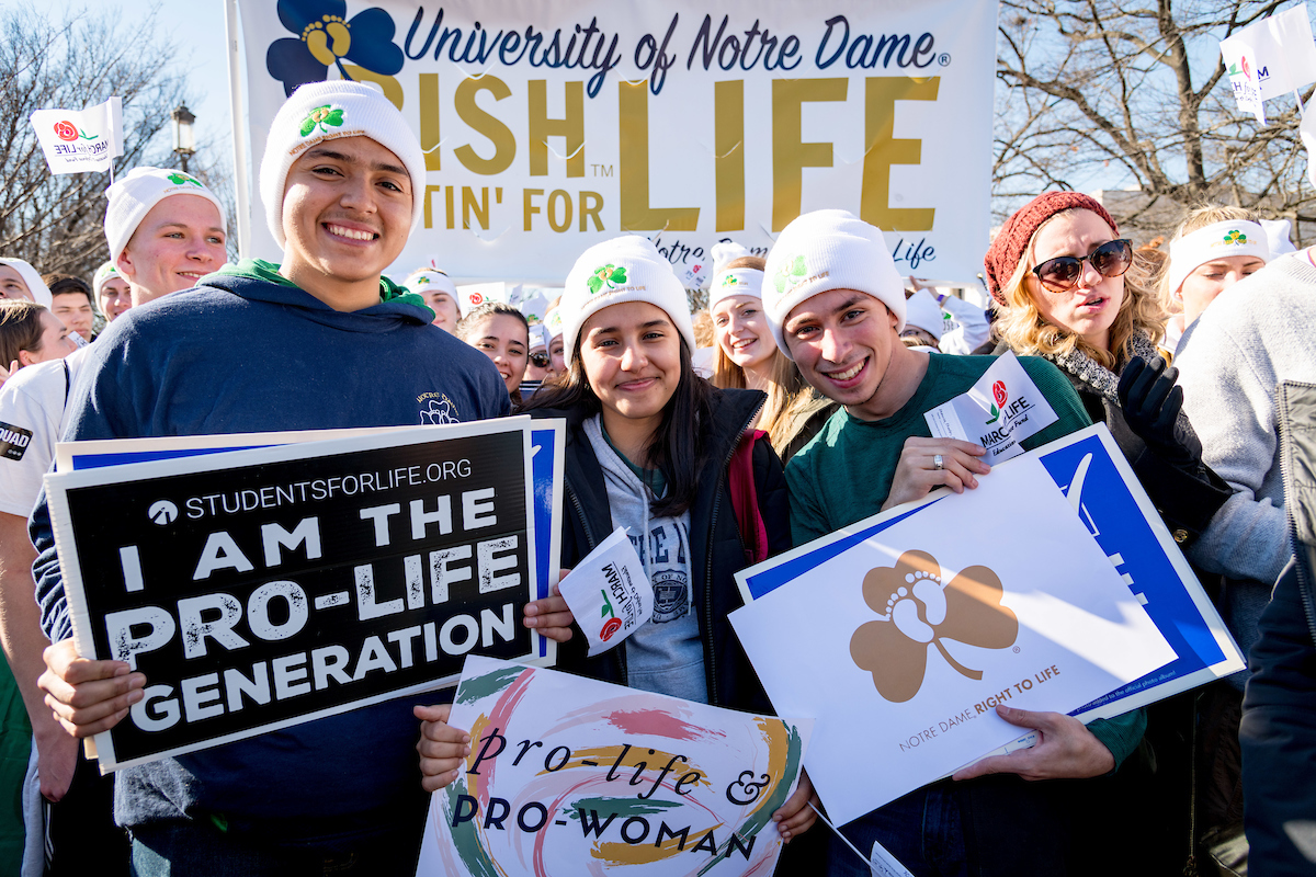 A group of young people at the March for Life standing in front of a sign saying Fighting Irish Fighting For Life