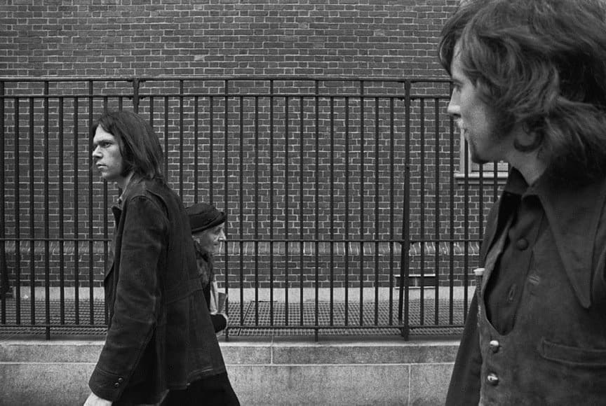 The Art of Album Covers. .Neil Young passing an elderly woman at 3rd & Sulllivan as Graham Nash looks on, New York City, June 1970.Photo Joel Bernstein.Used on Neil's “After The Gold Rush” live album, released 1970.