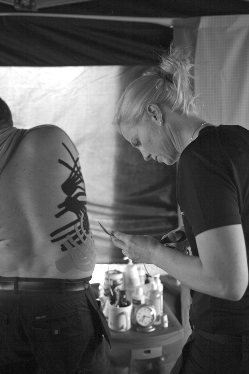 Scottphysio's tweet photo. Throwback Thursday- from about 2010, this racer clipped a wall and was extensively bruised down his whole side, the grid when the taping was changed was impressive! This was taken by a French Photographer doing a study on women working in the paddock. #iomttoriginal #ttphysios https://t.co/fx0BR4lzyK