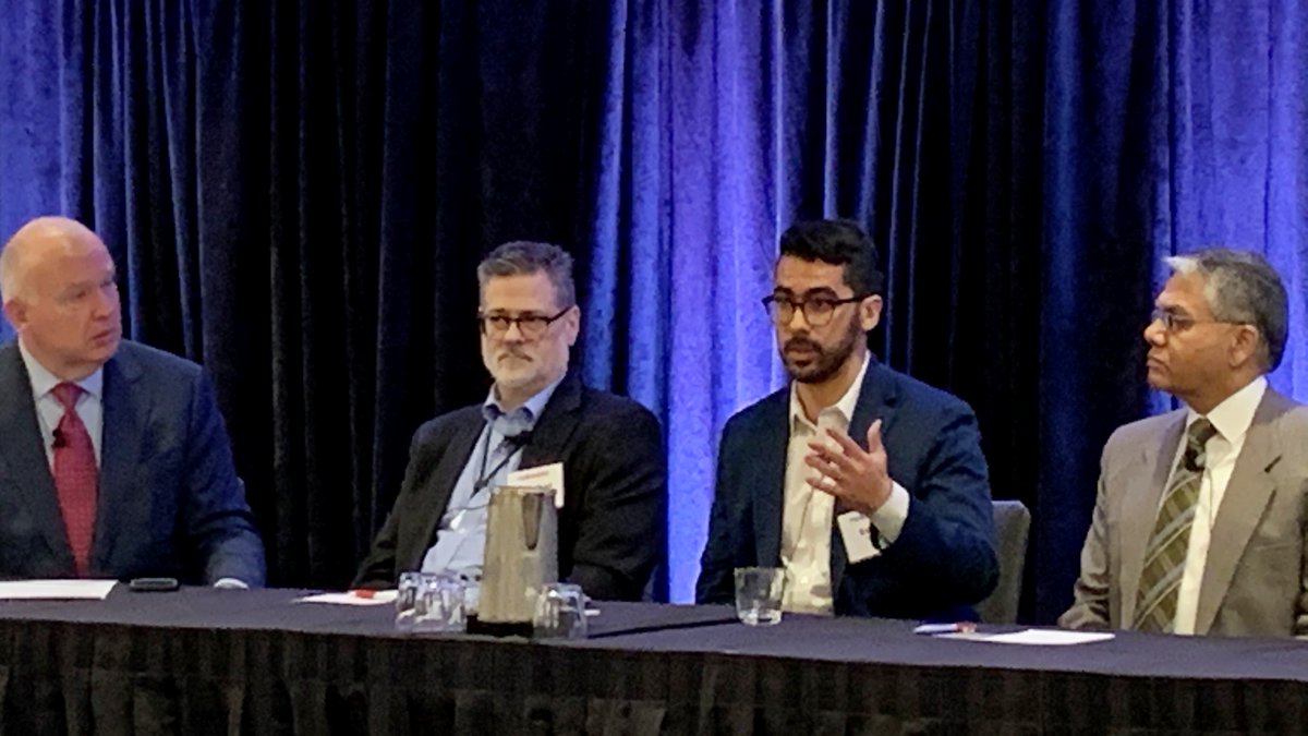 GSA Director of Cloud.gov, Eddie Tejeda, speaking at the event seated at a panelist table