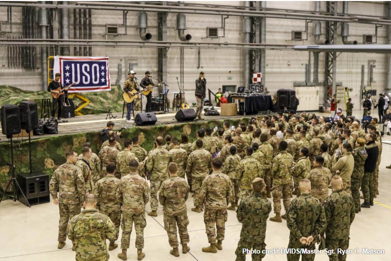 The_USO's tweet photo. Have you ever wondered what goes into making a USO show successful? Our tours would not be possible without collaboration with our military. Take a behind-the-scenes look at our overseas tour stop in Poland, from the eyes of a @USArmy soldier: https://t.co/T4wpqFm5Ta #USOTour2020 https://t.co/B0axZ2ytuN