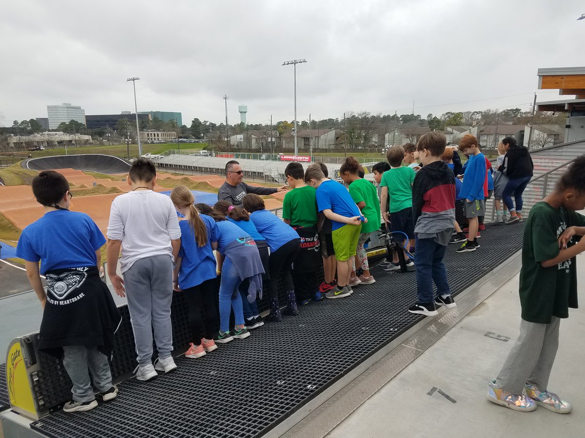 We are standing at the starting gate ready to run down the steep slope of the BMX track.