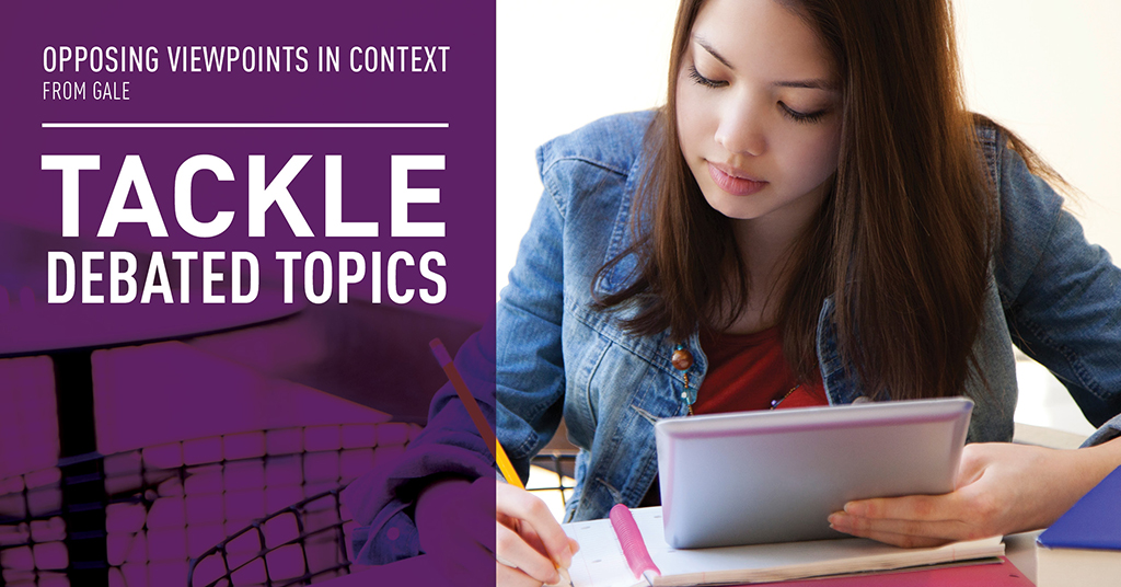 a young woman looking down on her notebook sitting at a desk, writing
