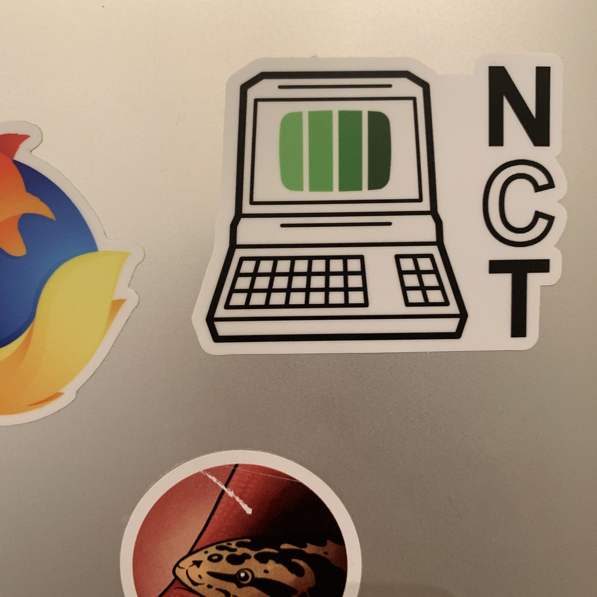 NormCore Tech sticker on my laptop next to a Hank (the snake) sticker