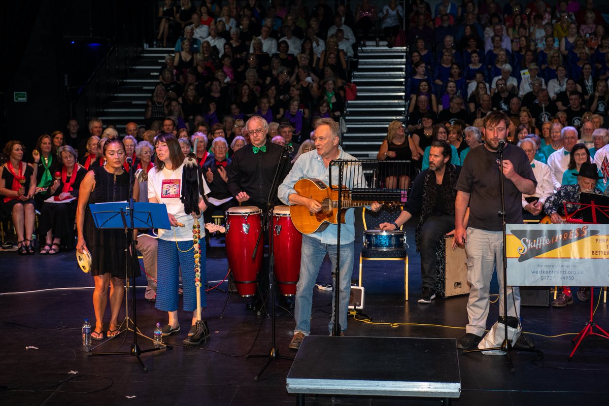 Band on stage singing and playing guitar