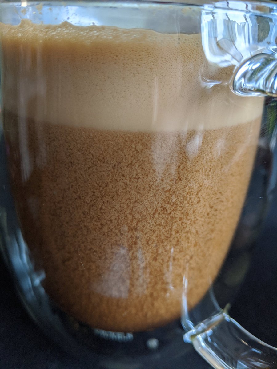 Side view of a latte with weird separation in the liquid.