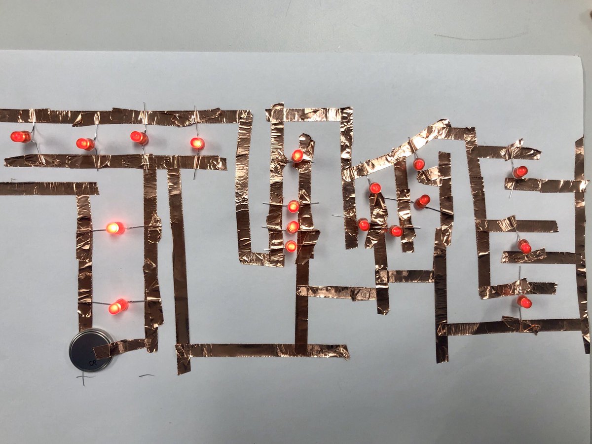 Copper tape circuit spells TIME with red LEDs connecting positive and negative lines