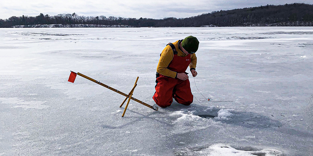ice fisherman setting up flag