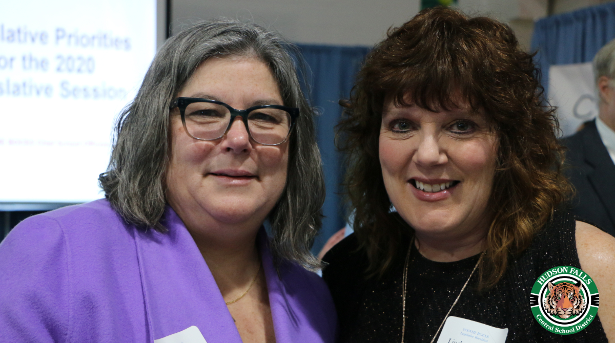 photo shows two adult women smiling at the camera