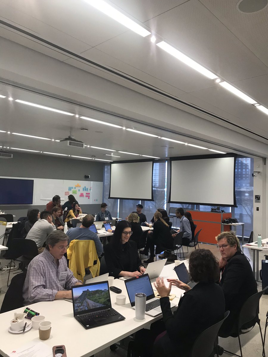 Workshop participants in discussion in a classroom.