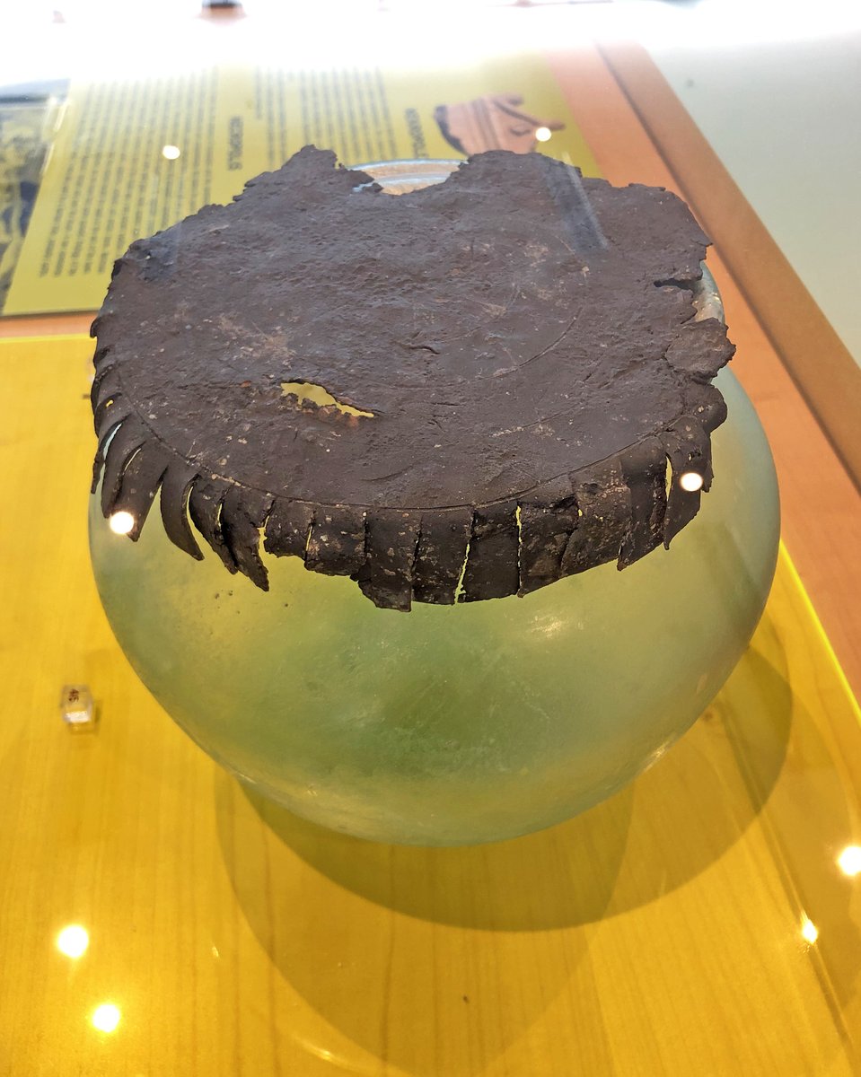 OptimoPrincipi's tweet photo. A Roman glass cinerary jar (olla) with its original lead lid. 2nd century AD, Narona Archaeological Museum #RomanDeath #Croatia https://t.co/1yDbG91ZJ4
