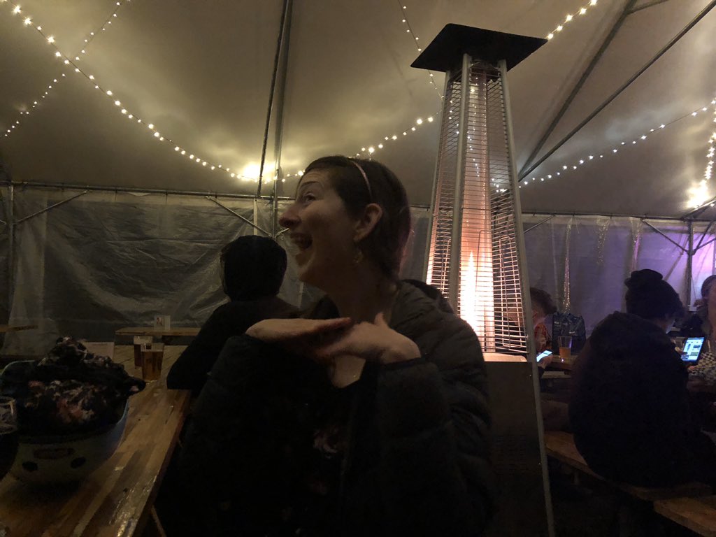 Bri poses in front of the gas fire heater