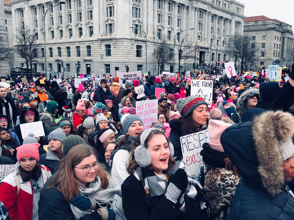 Crowd of people holding signs