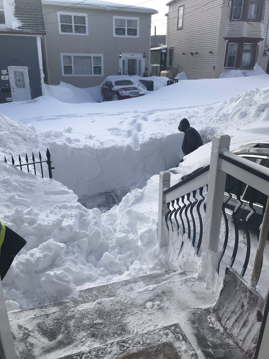 AshleyRaeNL's tweet photo. @NatashaFatah @CBCNL @sjmorningshow The view from my front door. That snow wall IS Pleasant Street in downtown St. John’s. (kind man with shovel for scale) https://t.co/nYAvyftzHX