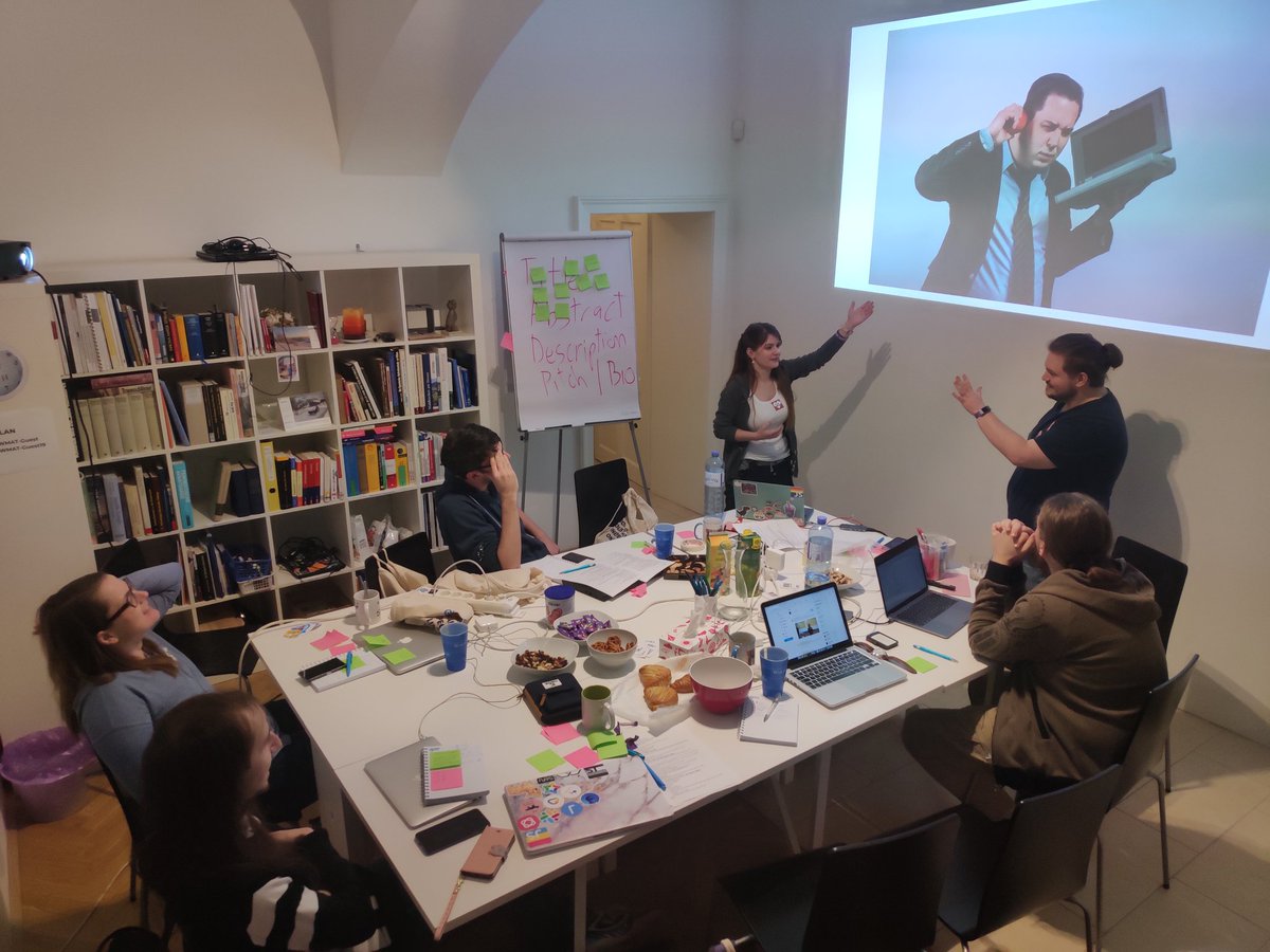 A group of people listening to someone giving a talk