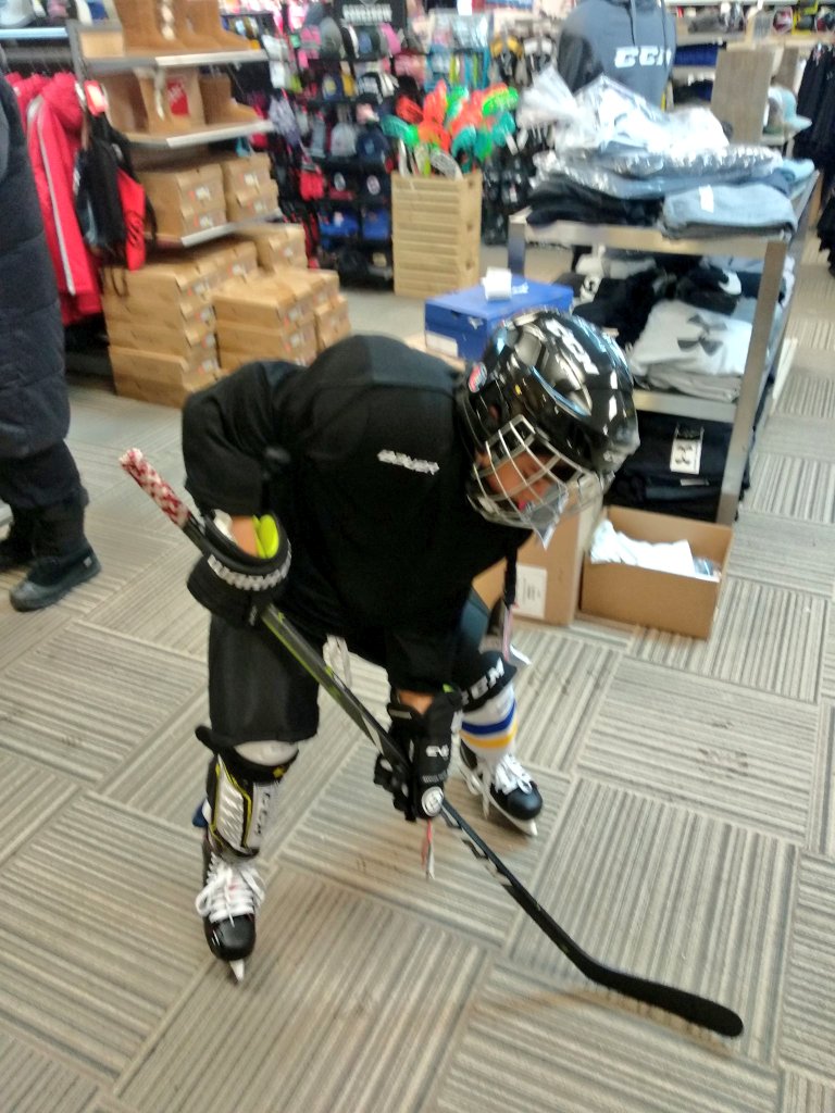 By the time Yaman walks in, he’s smiling ear to ear.They tell him he's getting brand new hockey gear. He’s so happy that he literally goes around shaking every single person’s hand, one by one.He chooses a Sidney Crosby stick, but there’s more.Look closer.