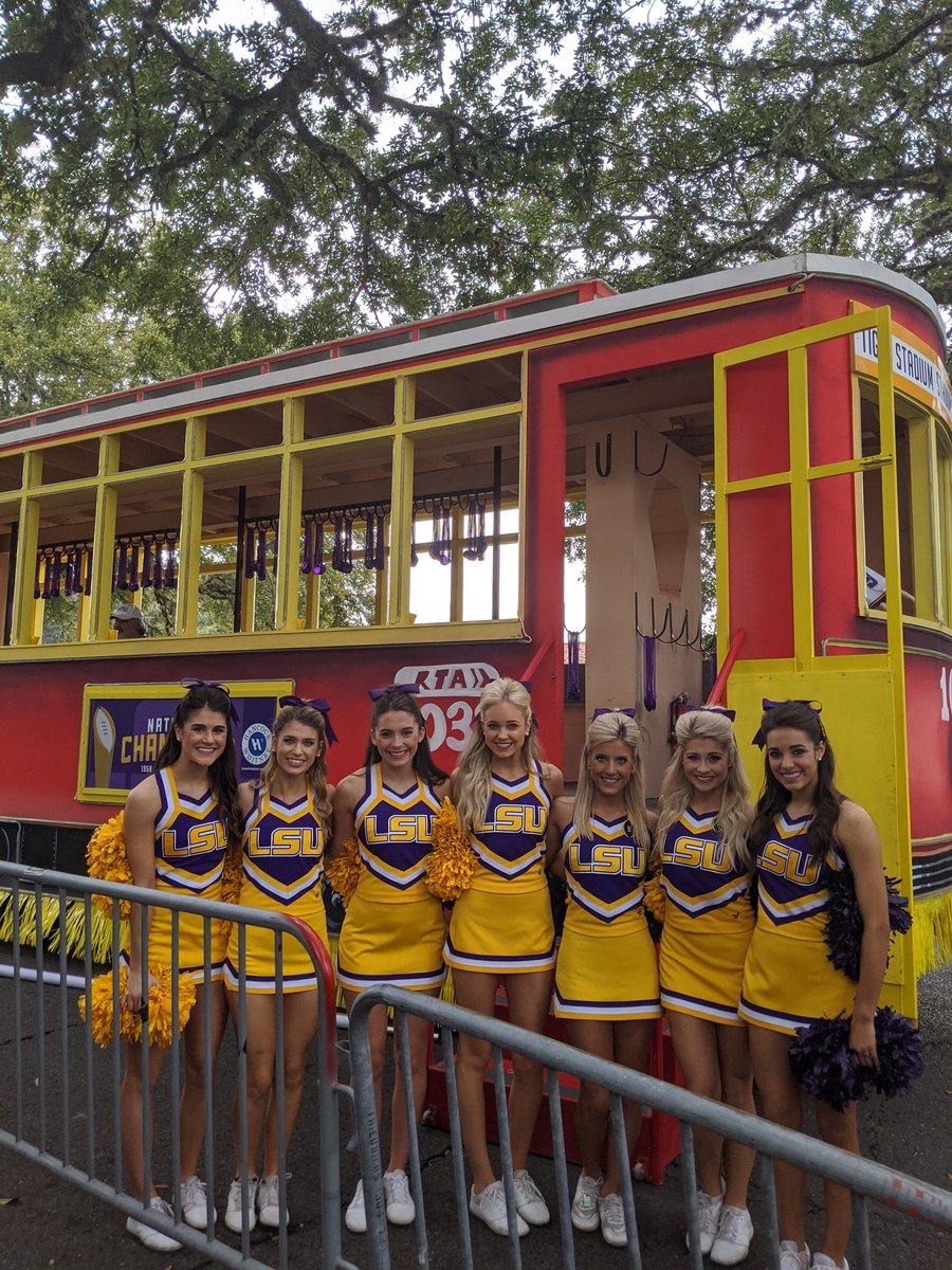 LSU cheerleaders before the parade near a float.