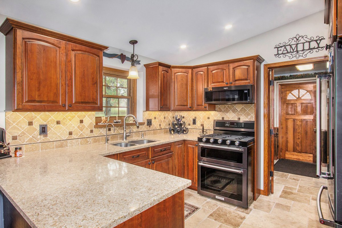 Kitchen Remodel.
_
In this #remodel, we replaced cabinetry with cherry wood cabinets. In addition, quartz countertops, under counter mounted sink, tile backsplash, under cabinet LED strip lighting and tile flooring. #BuildRemodelGR #GrandRapids