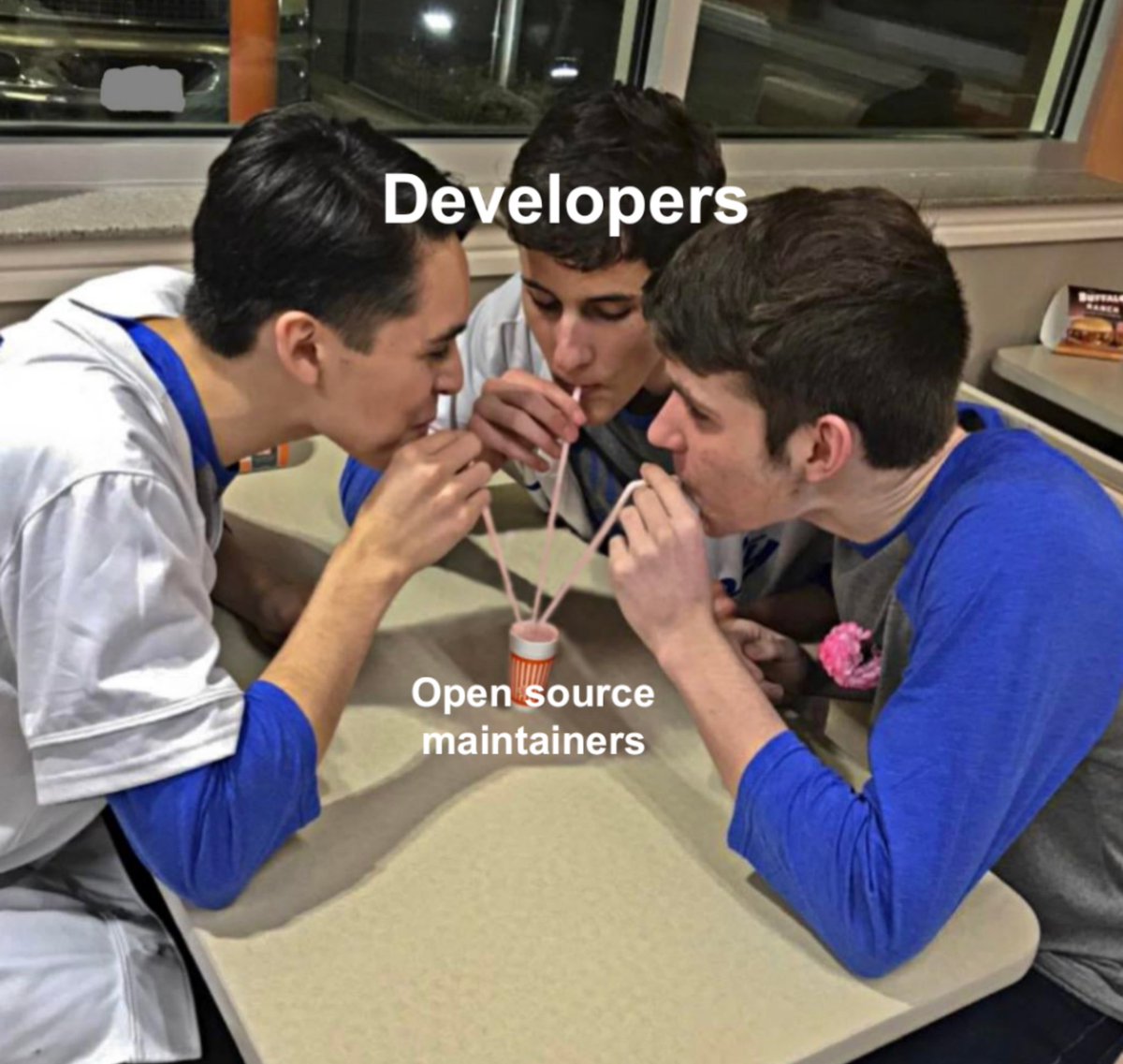 The people (developers) drinking though straws from a very tiny cup (open source maintainers)