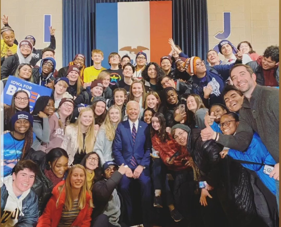 ErinNormal's tweet photo. Daniel is in Iowa with a group of Normal West HS students & teachers to meet with several candidates in pre-caucus activities. Daniel is in black shirt (pride logo) back row behind @JoeBiden. I'm proud of the students' desire to be heard. #unit5pride #normalwest #myheartisfull https://t.co/zIQePDInHP