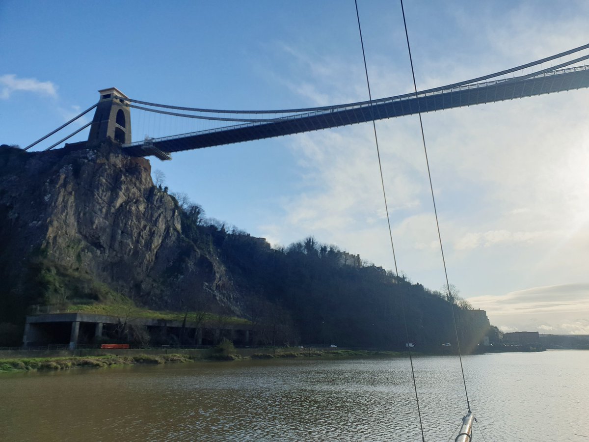 Motoring under the suspension bridge on our way to get our masts lifted out