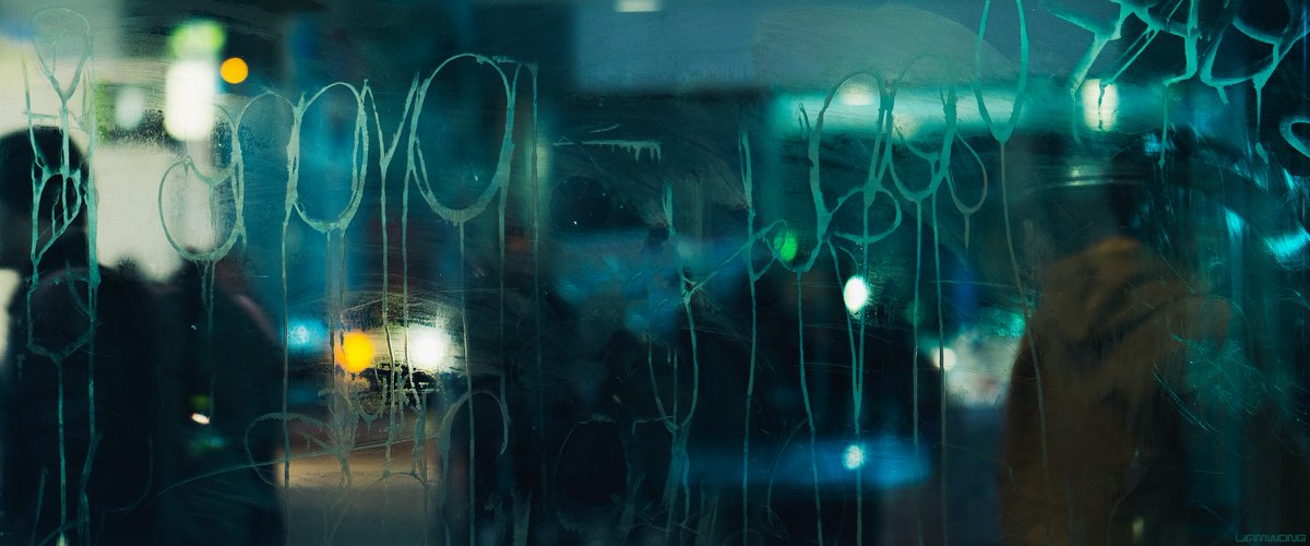 Photography by Liam Wong of Tokyo at night. A close-up of graffiti on the train station shelter, made out of plastic. It feels grungy and very dirty. It is captured in Shibuya's scramble crossing. Vague silhouettes of people are seen passing by the plastic/glass. It is teal in color.