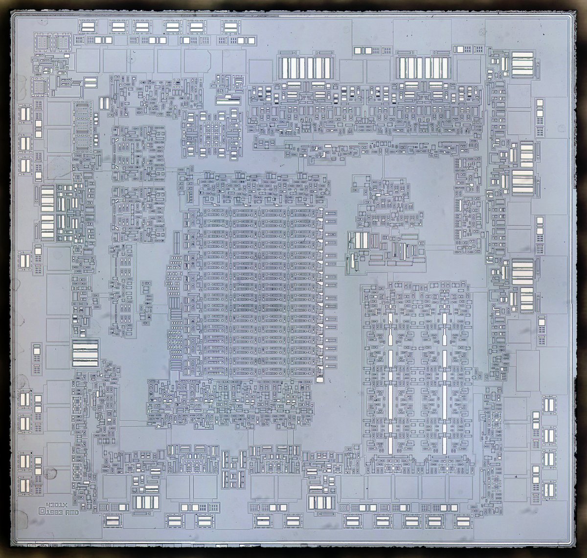 Die photo of Am2901 chip with metal layer removed. Die is bluish, with small transistors.