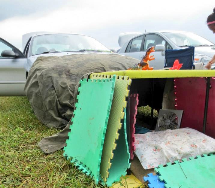 This is the table that my Bonnaroo neighbors snorted lines off of. You can see the nest I built to sleep under. Roo is fuckin' hot and it made for good shade!The bloody baby backpack was my free candy dispenser. I jammed suckers into its head then let strangers pluck them free.