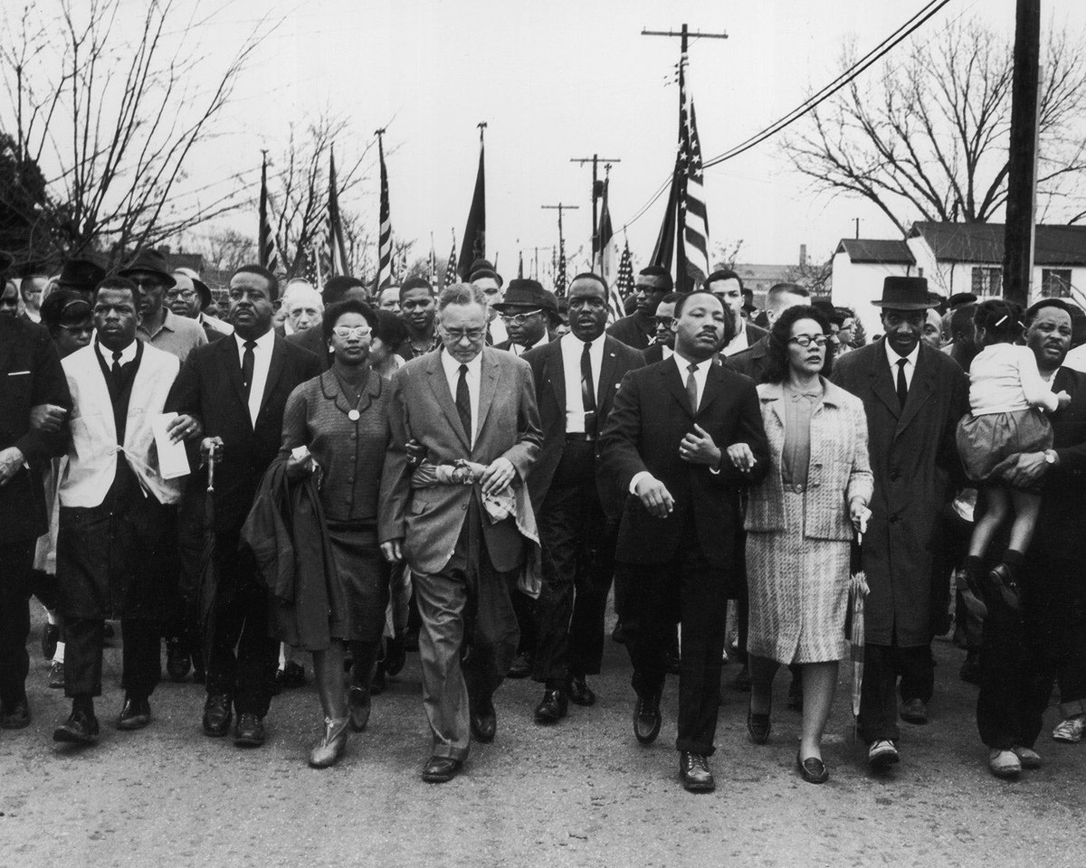 A photo of MLK marching with justice leaders