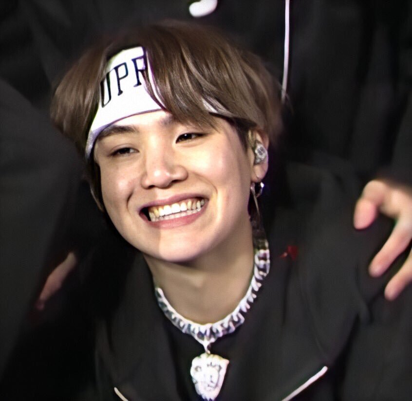You might be able to resist the cat eyes and the growly voice and the perfect skin (can you really though?). But once he flashes his gummy smile at you, Min Yoongi has you.