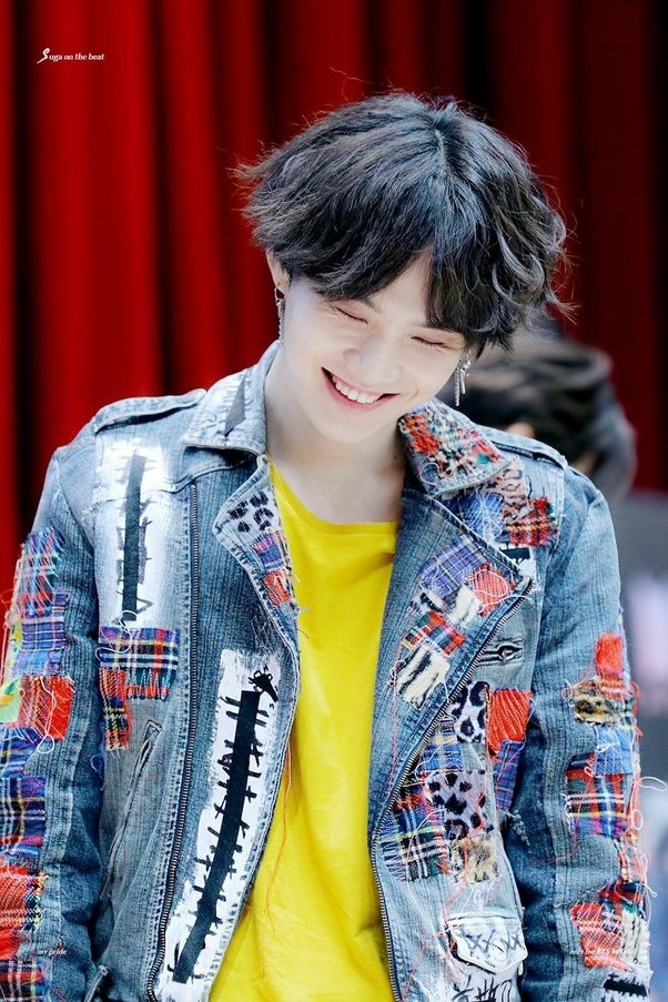 You might be able to resist the cat eyes and the growly voice and the perfect skin (can you really though?). But once he flashes his gummy smile at you, Min Yoongi has you.