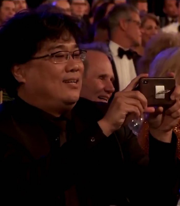 bong joon-ho taking a photo of the parasite cast at SAG