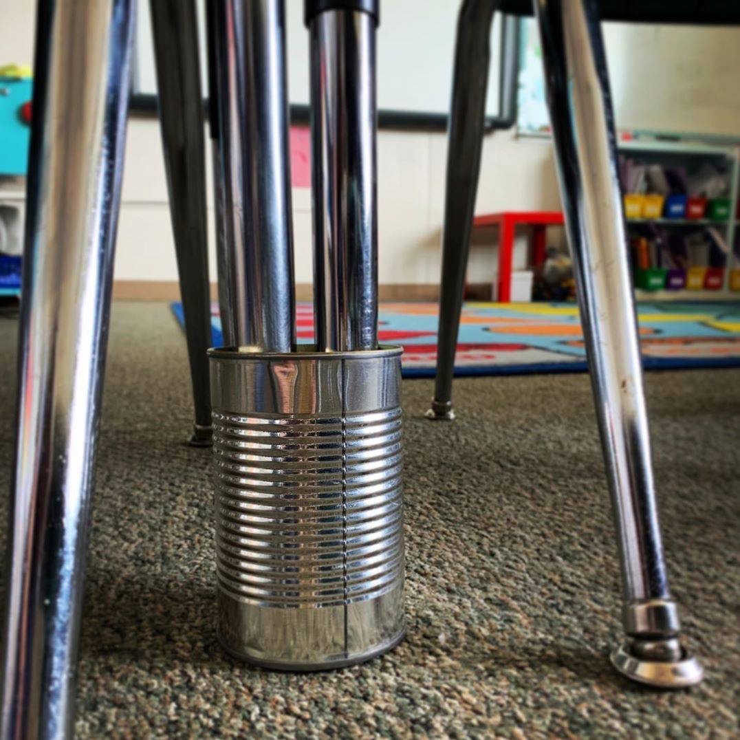 Cbgardner16's tweet photo. A2: I loved moving my students around in my classroom and grouping their desks/tables differently, but I always hated how much the desks would move and wiggle. Saw this hack and thought it was a great idea. Use an empty can to keep desks grouped together. #edhacks #ksedchat https://t.co/rIdBswRxFo