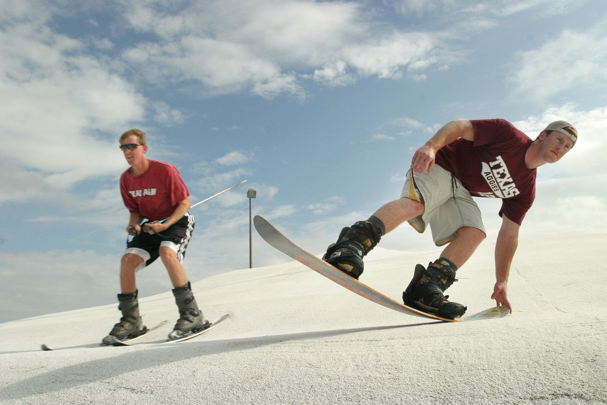 Student on snowboard and student on skis behind him at Mt. Aggie